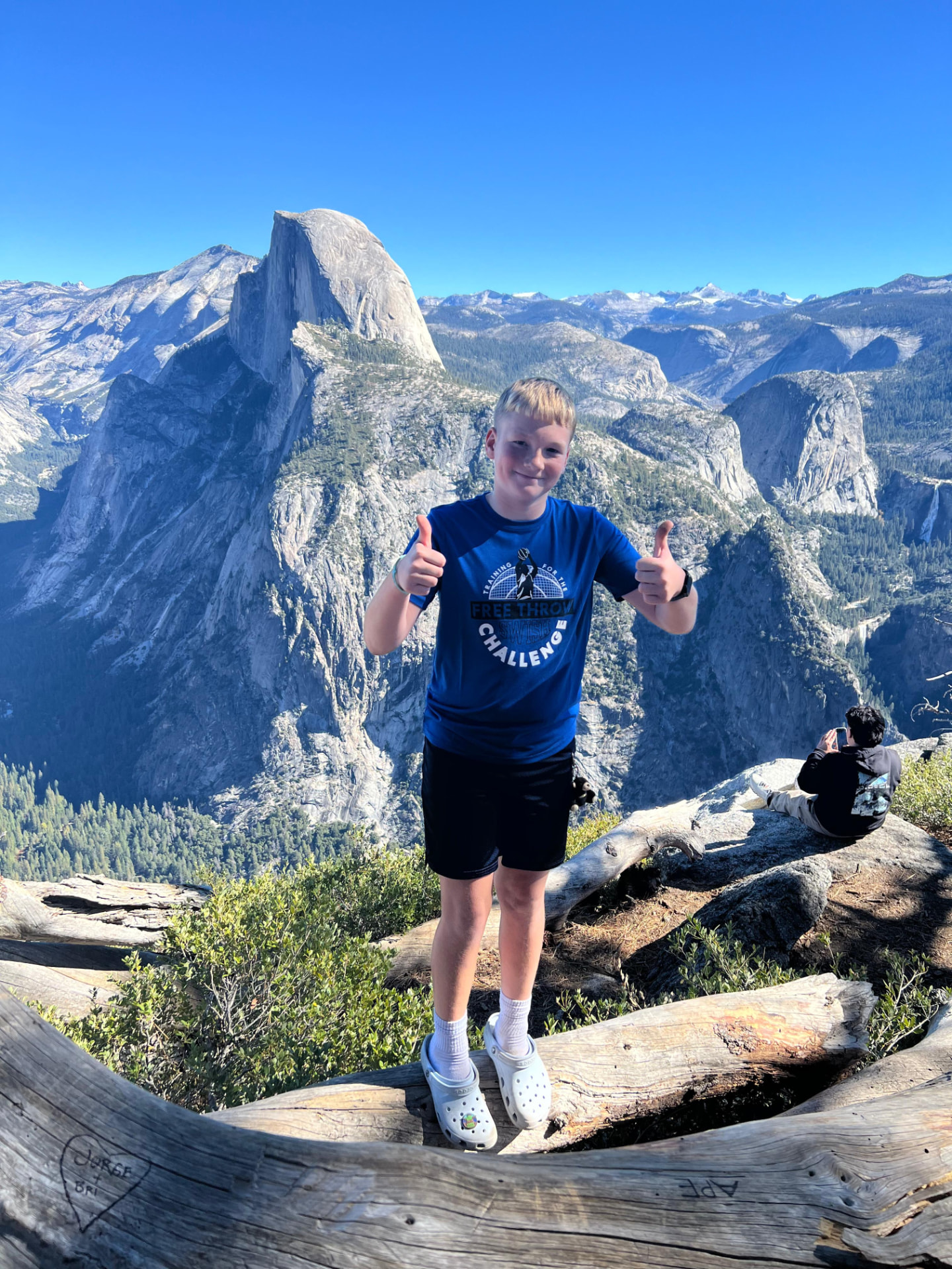Keaton giving two thumbs up in front of Half Dome in Yosemite